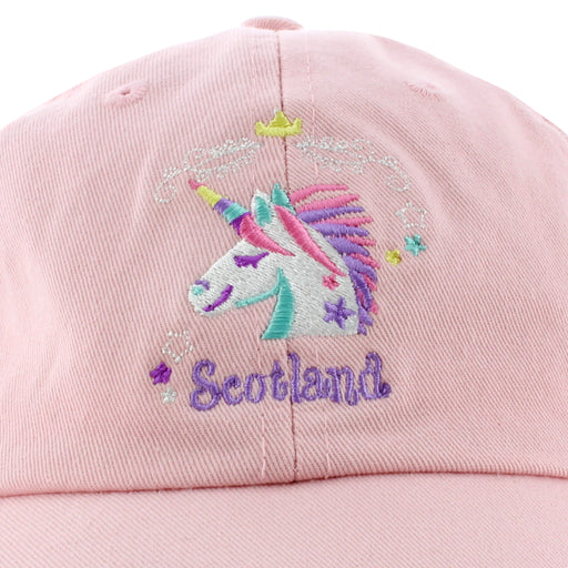 embroidered unicorn logo on pink cap with word scotland in lilac below motif