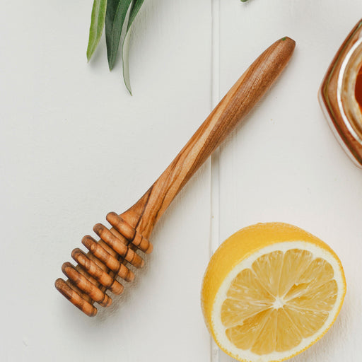 Wooden Honey Dipper shown next to lemon in close up detail