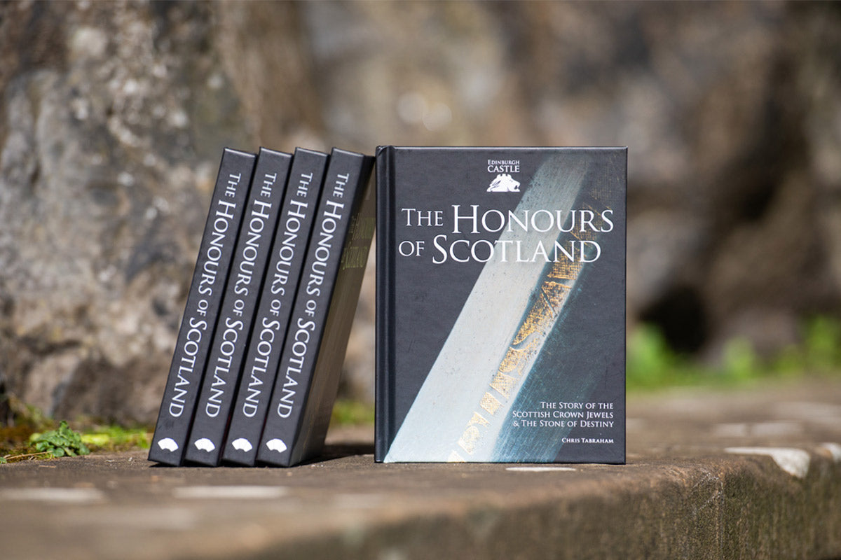 honours of scotland book show on stone wall with few copies stacked side by side
