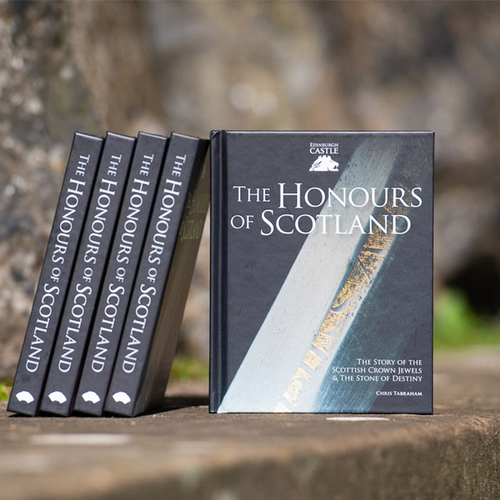honours of scotland book show on stone wall with few copies stacked side by side