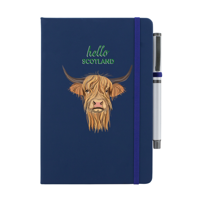 Soft Touch navy notebook featuring a Highland Cow and the test reads 'hello SCOTLAND'. A navy strap closes over the right hand side with a matching pen.