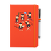 A beautiful designed orange notebook featuring a vibrant illustration of dancing piper bears in red and black, playing bagpipes joyfully. An orange strap closes over the right hand side with a matching pen.