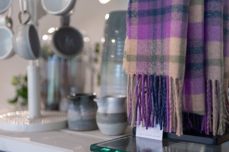 image of caerlaverock retail shop detail and coorie tartan scarf