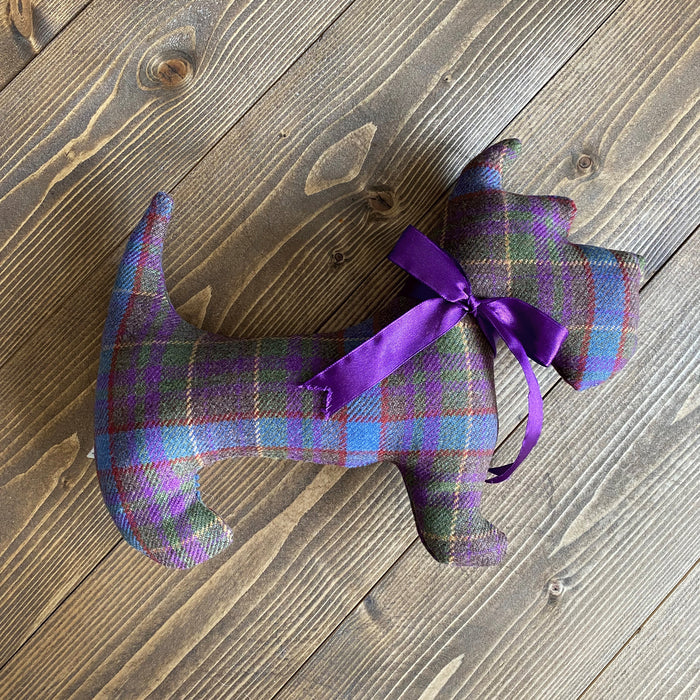 Grassmarket Tartan Cushion in the shape of a Scottie Dig with a purple ribbon. 