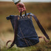 detail shot of hand holding fernweh bag outdoors