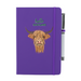 Soft Touch purple notebook featuring a Highland Cow and the test reads 'hello SCOTLAND'. A purple strap closes over the right hand side with a matching pen.