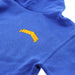 Close up of the front of a blue hoodie showing a yellow design that reads 'SCOTLAND'. 