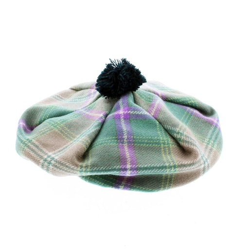 A green and purple tartan 'Tam' hat with a green pompom on top. 