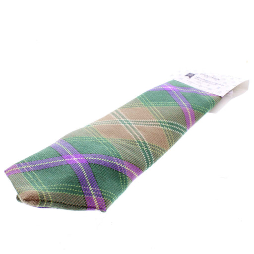 Green and purple tartan wool tie laid flat. 