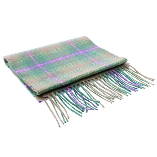 A green and purple woolen tartan scarf is folded neatly. 