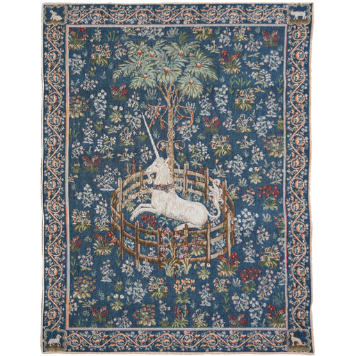 Blue Woolen Tapestry that depicts the 'Captive Unicorn'. The white unicorn is penned in and surrounded by flowers and shrubs. 