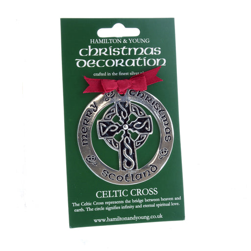 Silver Celtic Cross with a red ribbon on a green display card. 