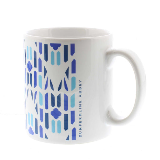 White ceramic mug with a blue all over print inspired by Dunfermline Abbey Windows. Text on the side reads 'Dunfermline Abbey'. 