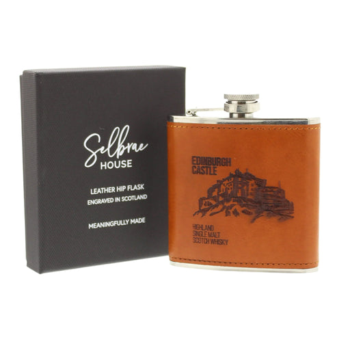 A beautiful  brown leather hip flask featuring  Edinburgh Castle, with 'Highland And Single Malt Scotch Whisky' text, nestled in a black gift box.