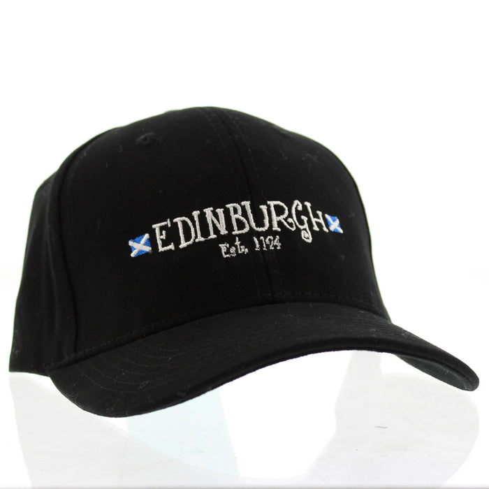 Black Baseball Cap featuring white embroidery that reads 'Edinburgh Est 1124' enclosed by two St Andrews flags. 