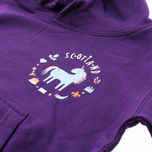 Close up of the Unicorn design on the left hand chest of a purple hoodie. The unicorn is surrounded by royal emblems and the word 'SCOTLAND' above. 