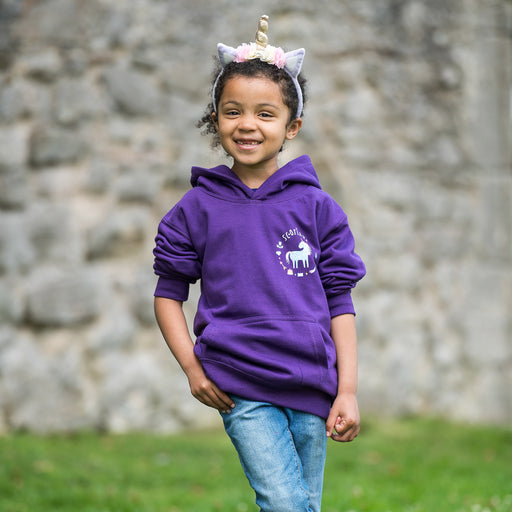 Child wears the purple Enchanted Hoodie along with a unicorn headband. 