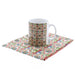 Fleur De Lys printed Cotton Teatowel folded flat with the matching mug on top. 