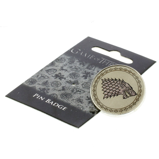 The Game of Thrones Pin Badge features the head of a wild animal. The Badge is laid next to a black and grey display card. 