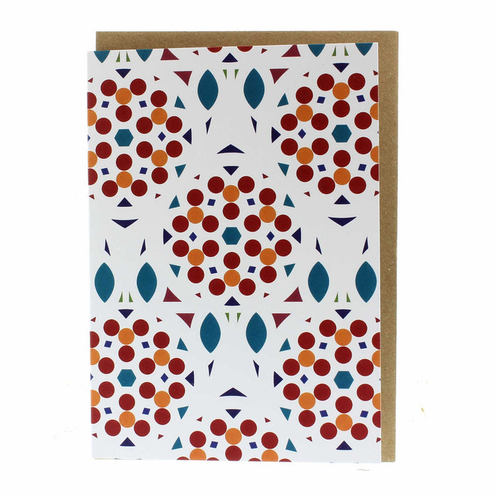 White greeting card featuring a red, orange and blue circular print. 