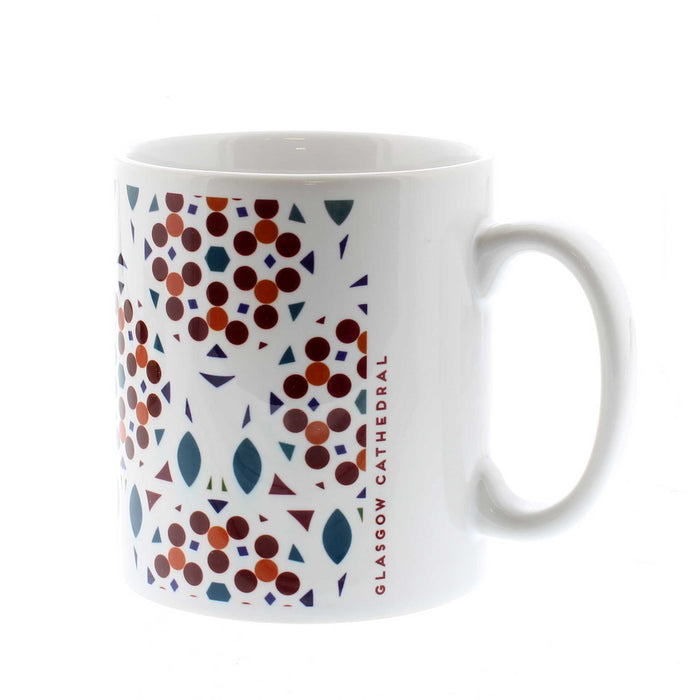 White ceramic mug featuring a red, orange and blue circular print. The text on the side reads 'Glasgow Cathedral'. 