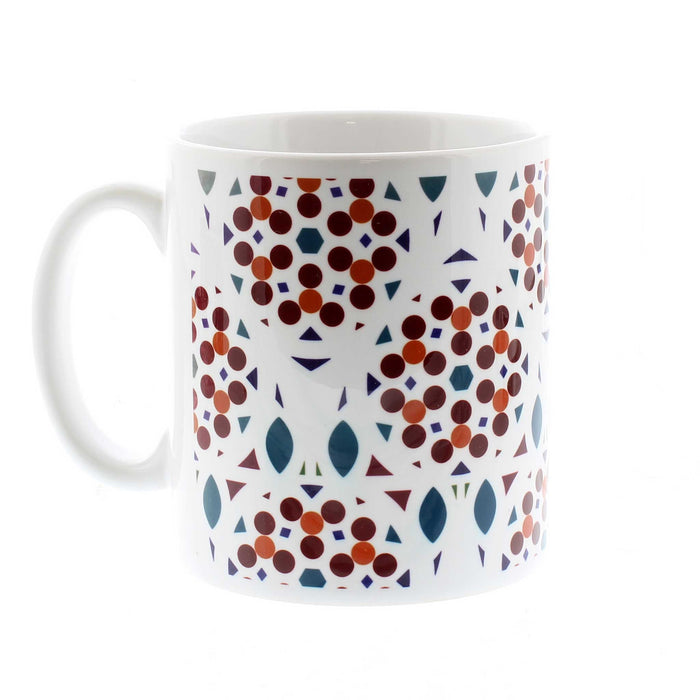 White ceramic mug featuring a red, orange and blue circular print.