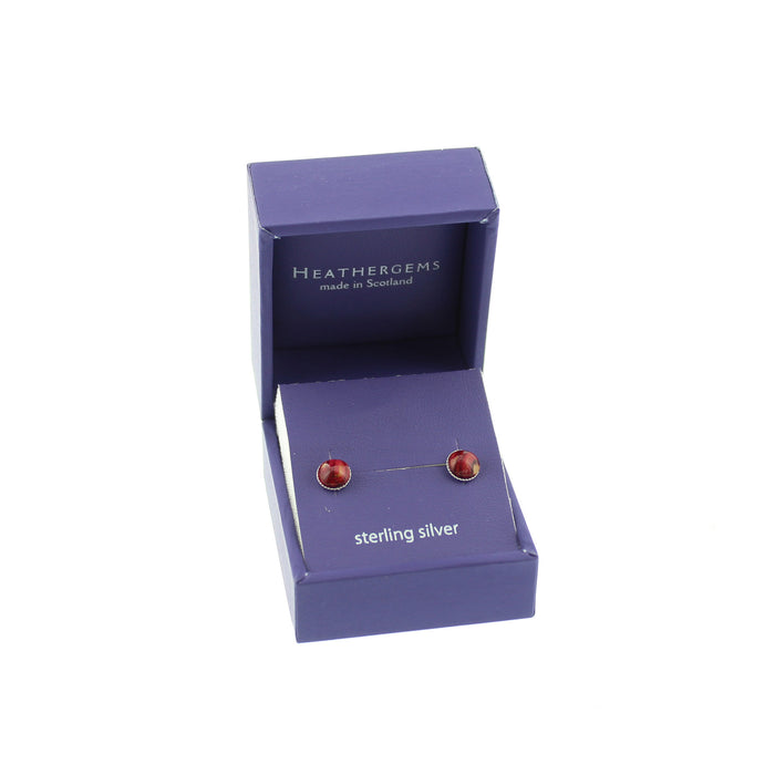 Purple box containing small Sterling Silver stud earrings with a red resin stone made from Scottish Heather