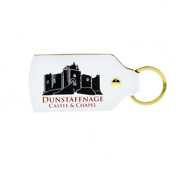 White leather oblong shaped keyring with gold hardware. The print shows a greyscale image of Dunstaffnage  Castle, underneath the text reads the castle name in red.