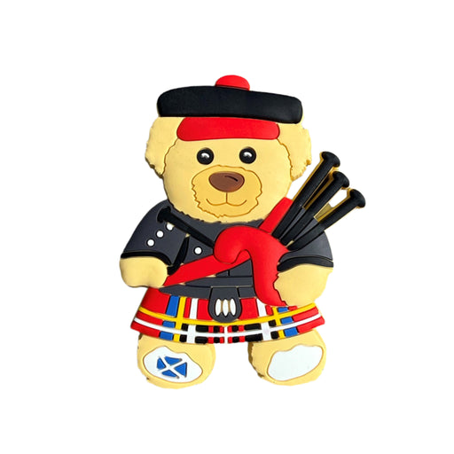 PVC Magnet depicting a teddy bear dressed up in Highland dress and playing the bagpipes.  - Image