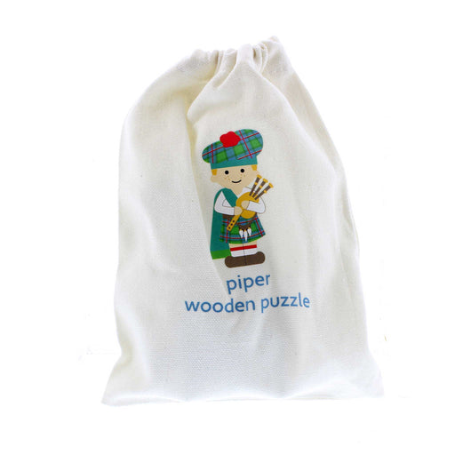 The white cotton bag that comes with the Piper Puzzle Toy features a print of the piper on the front with blue text underneath that reads 'piper wooden puzzle'. 