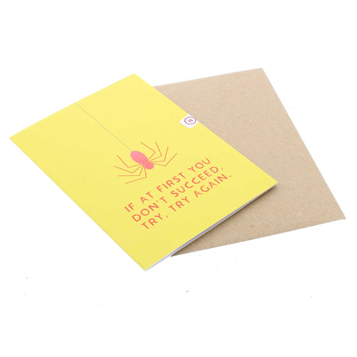 The yellow card is laid flat with it's brown paper envelope. 