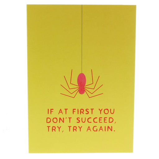 A yellow greeting card features a red spider on a string with the text underneath reading 'If at first you don't succeed, try, try again' in red. 