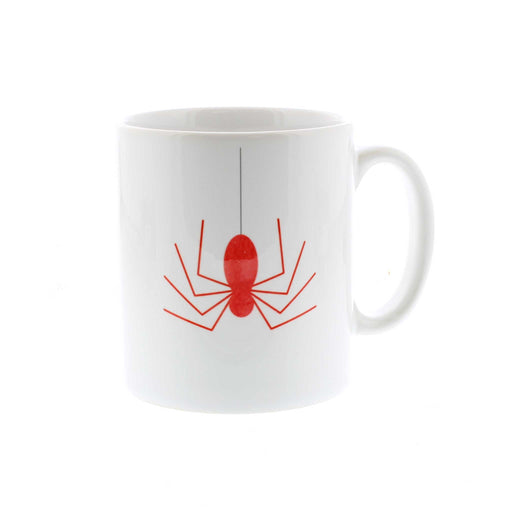 A white ceramic mug with a print of a red spider. 