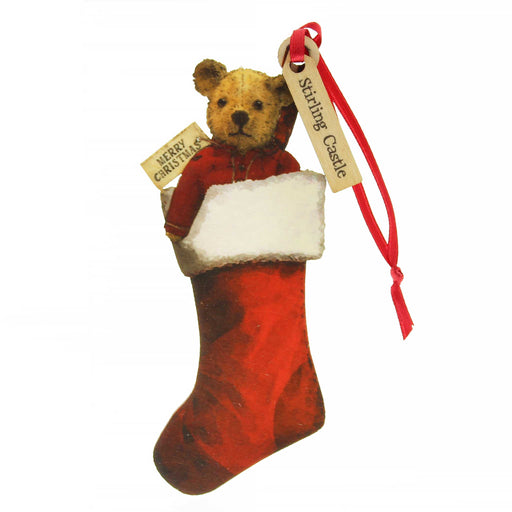 Small wooden tree decoration in the shape of an old fashioned Teddy Bear. The teddy is popping out of the top of a Red Stocking and has a red ribbon for hanging. A small tag on the ribbon reads 'Stirling Castle'. 