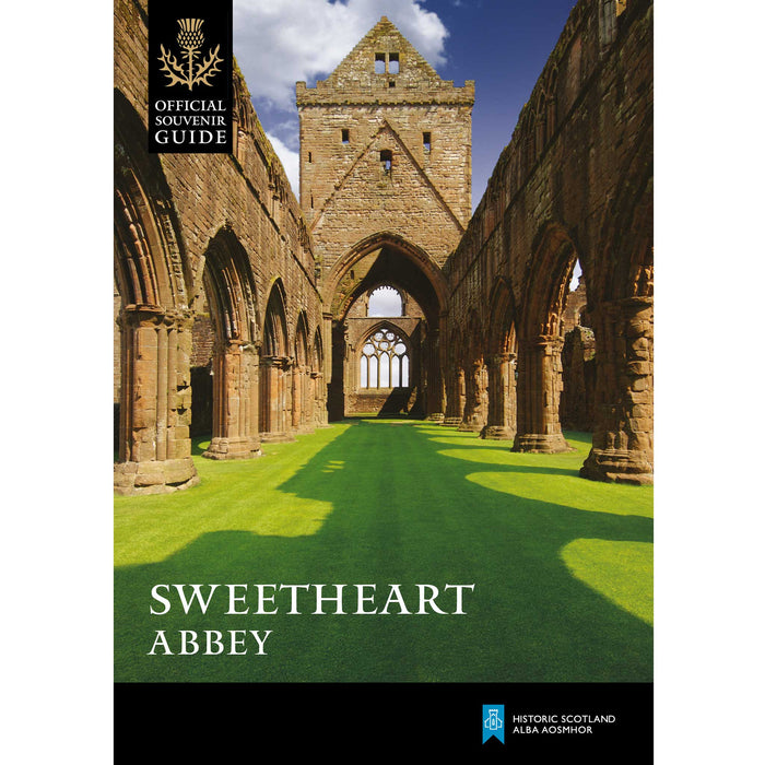 The front cover of the Sweetheart Abbey guidebook features a photographic print of the Abbey ruins. Green grass runs through the the Abbey walls and a bright blue sky is overhead. 