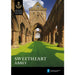 The front cover of the Sweetheart Abbey guidebook features a photographic print of the Abbey ruins. Green grass runs through the the Abbey walls and a bright blue sky is overhead. 