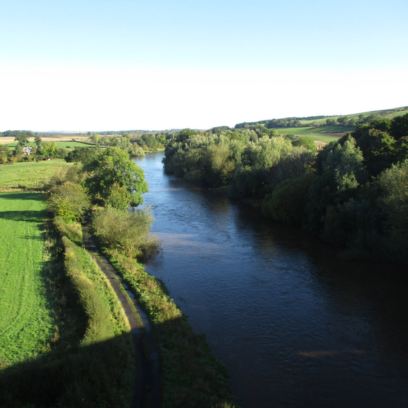 The River Teviot and surrounding landscape on a sunny day. 