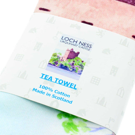 Close up of White cotton tea towel featuring a bright coloured print of Urquhart Castle on the banks of Loch Ness.