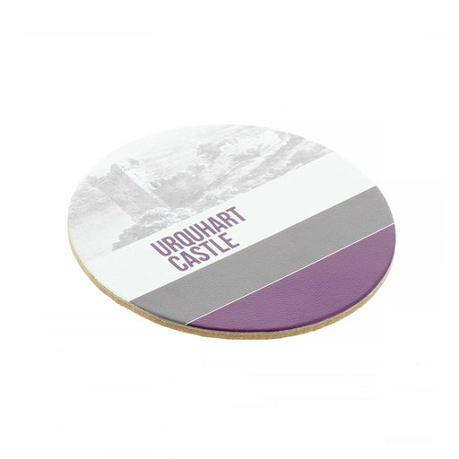 The round leather Urquhart Castle Coaster features a sketch of the castle at the top with the words 'Urquhart Castle' underneath. This is followed by a grey then purple stripe. 