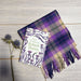 The Poetry of Robert Burns Book laid on the Coorie Tartan Scarf next to thistles 