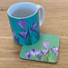 Crocuses printed mug and coaster on a wooden kitchen top