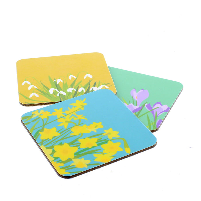 Trio of brightly coloured coasters featuring a daffodil print, crocus print and a snowdrop print.