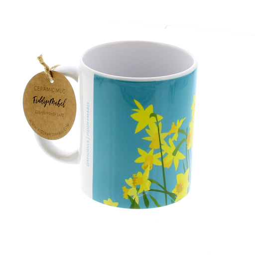 Bright blue ceramic mug with a bold yellow daffodil print.