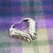 Silver winged brooch sits on the Coorie Tartan Cashmere scarf.