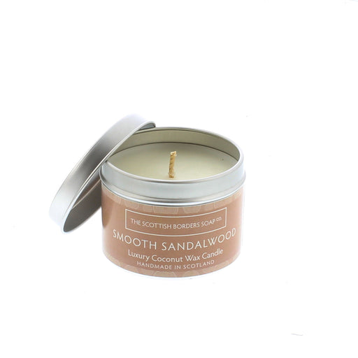 Silver Candle Tin with a light brown label contains a sandalwood scented candle. 