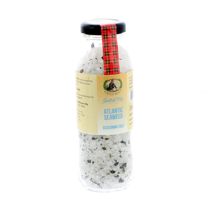 Scottish Seaweed Salt from the Atlantic Sea in a clear jar with a red tartan strip and black lid. 