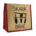 Hessian Jute Tote with a print of some of the stones left at Skara Brae. The words 'Skara Brae' are also printed on the shopper which has a natural colour with red sides, handles and trims. 