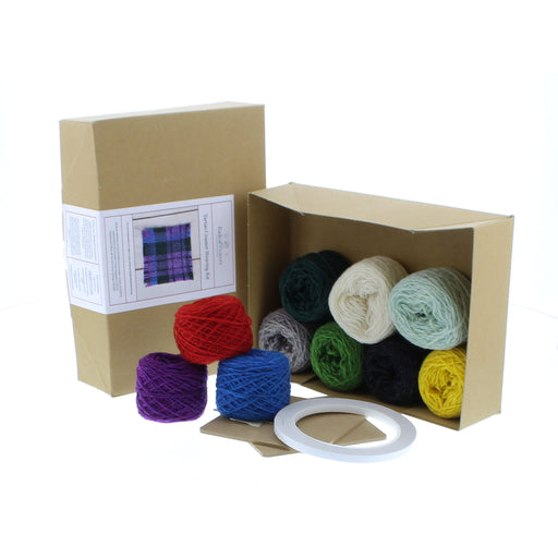 Contents of the Tartan Mini Coaster kit showing balls of coloured wool