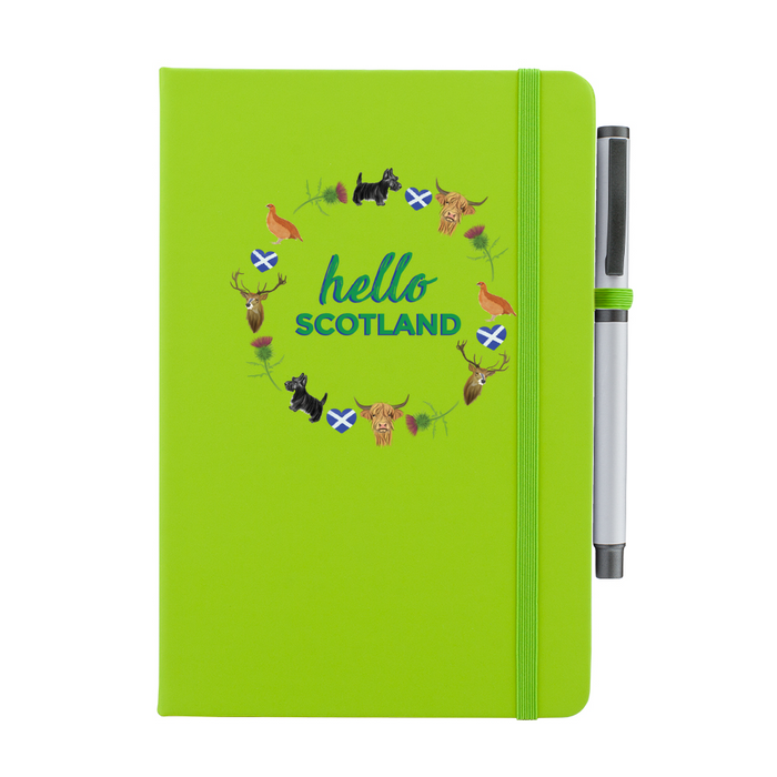 A beautiful designed lime green notebook with the words 'Hello Scotland' in green,  featuring elements of Scottish culture and scenery. A lime green strap closes over the right hand side with a matching pen.