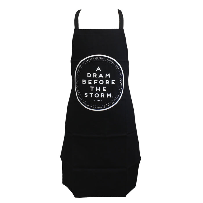 black cotton kitchen apron with words a dram before the storm surround with Scottish place names including speyside and lowlands